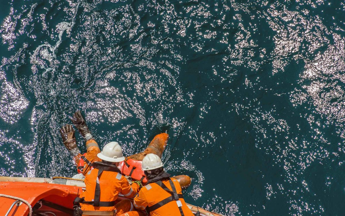 Marine crews of a pipelay barge performing man overboard emergency rescue drill at Kemaman Port Anchorage